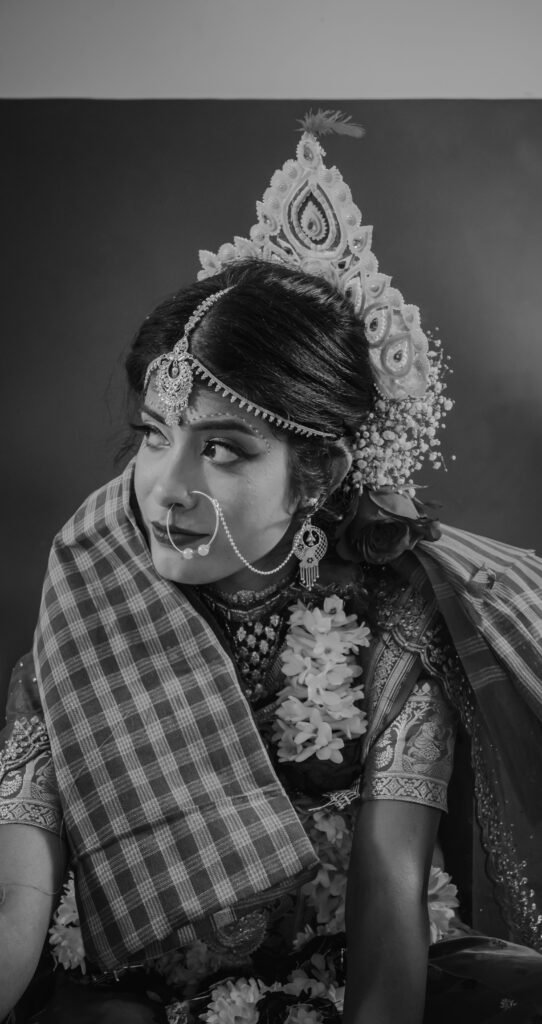 Elegant portrait of a traditional Indian bride wearing intricate jewelry and a headdress.